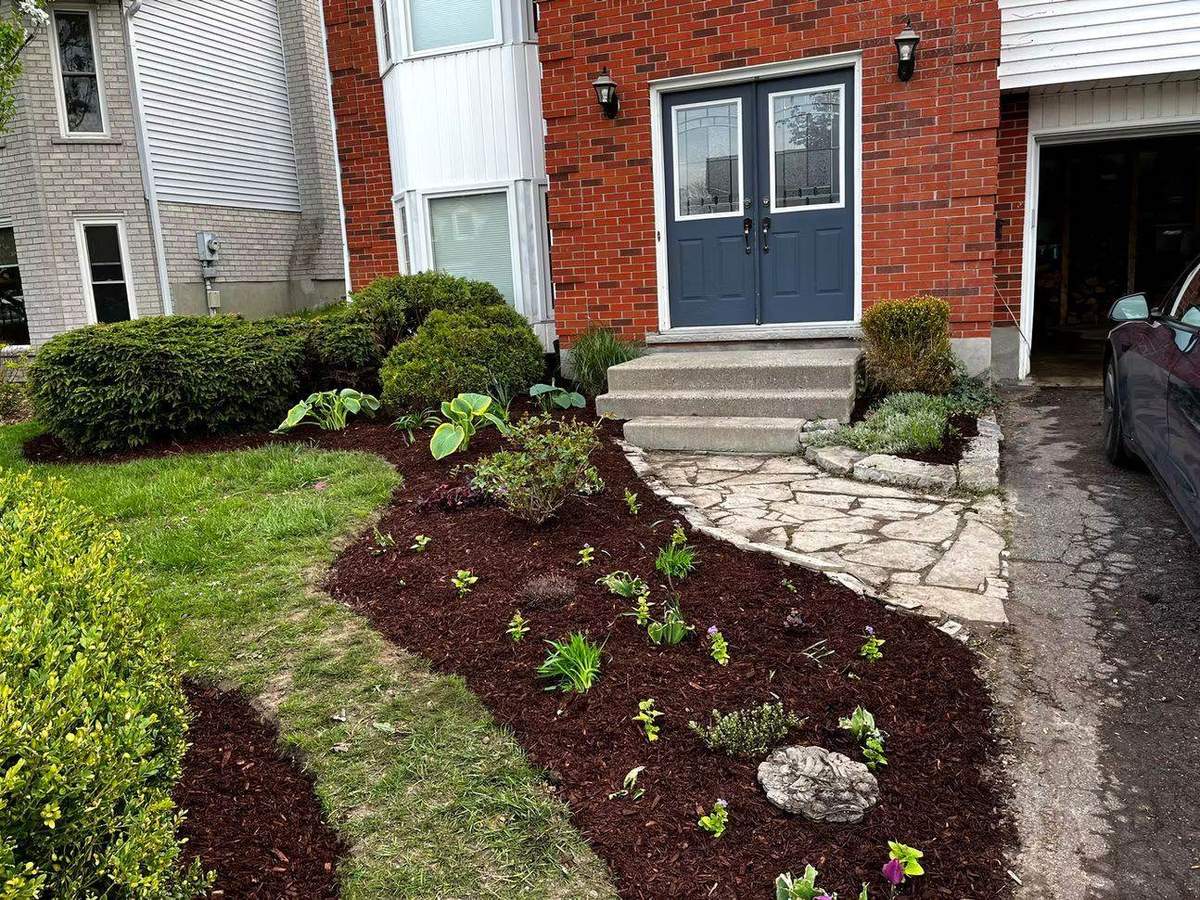 Tidy front porch garden beds in Guelph